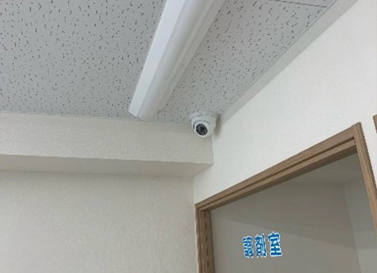 受付前の天井コーナーに設置した小型ドーム型防犯カメラ